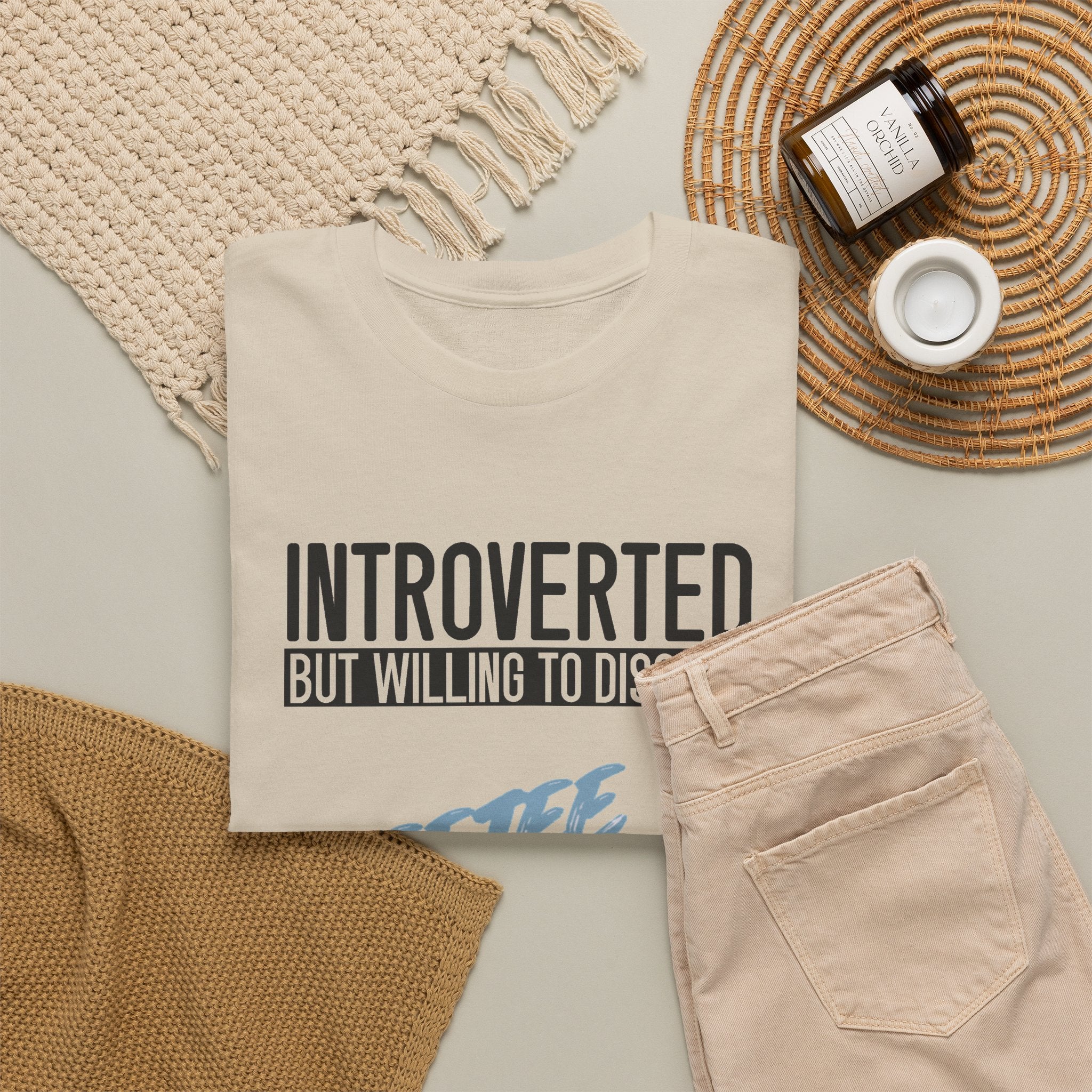 Sand Introverted TeeteePor slogan tee, flat-lay styled with neutral props